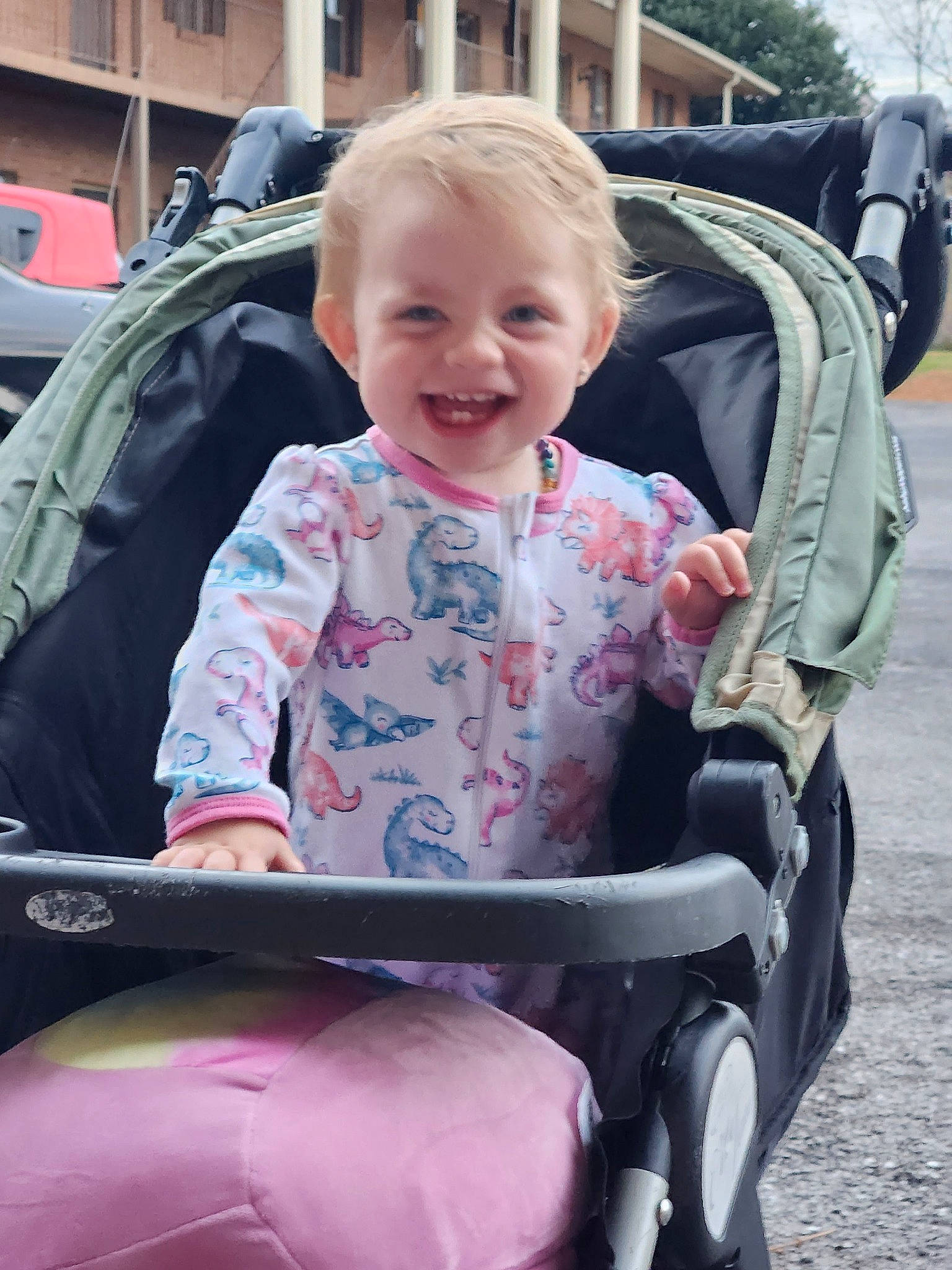 Jensen joined the competition — help win amazing prizes! baby, baby_carriage, baby_products, baby_toddler_clothing, child, comfort, fun, grass, joy, lap, leisure, motor_vehicle, person, pink, product, recreation, sitting, smile, tire, toddler