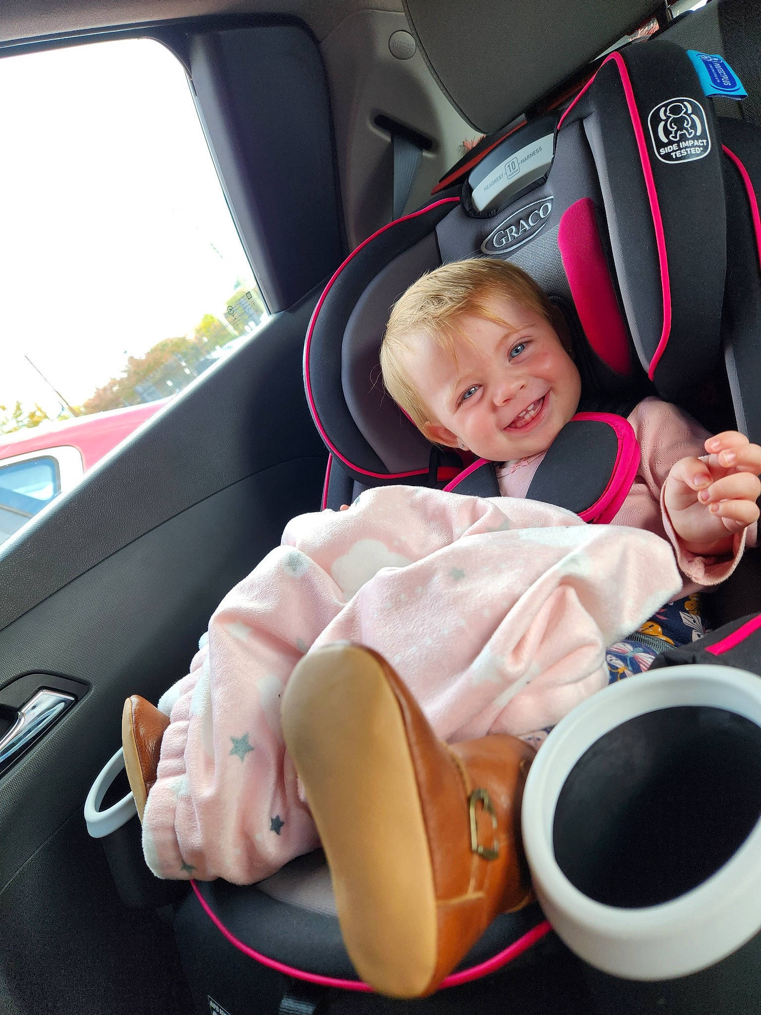 Jensen is registered to the contest to win money with this photo: auto_part, automotive_design, automotive_exterior, baby, baby_in_car_seat, baby_toddler_clothing, car, car_seat, car_seat_cover, child, comfort, joy, motor_vehicle, person, personal_luxury_car, seat_belt, smile, steering_wheel, toddler, vehicle