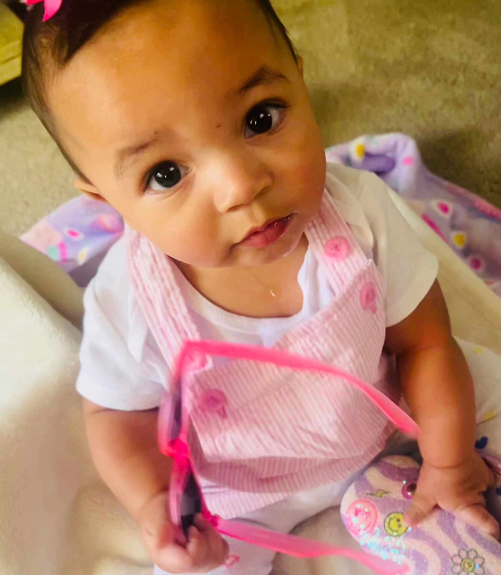 Calliah joined the competition — help win amazing prizes! baby, infant, child, pink_clothing, white_shirt, glasses, toy, blanket, cute, curious, sitting, indoors, closeup, face, eyes, hand, soft_toys, playtime, portrait, young_child
