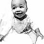 baby, infant, smile, happy, face, bib, clothing, person, child, portrait, black_and_white, cute, sitting, young, small, cute_expression, indoors, soft_light, closeup, joyful