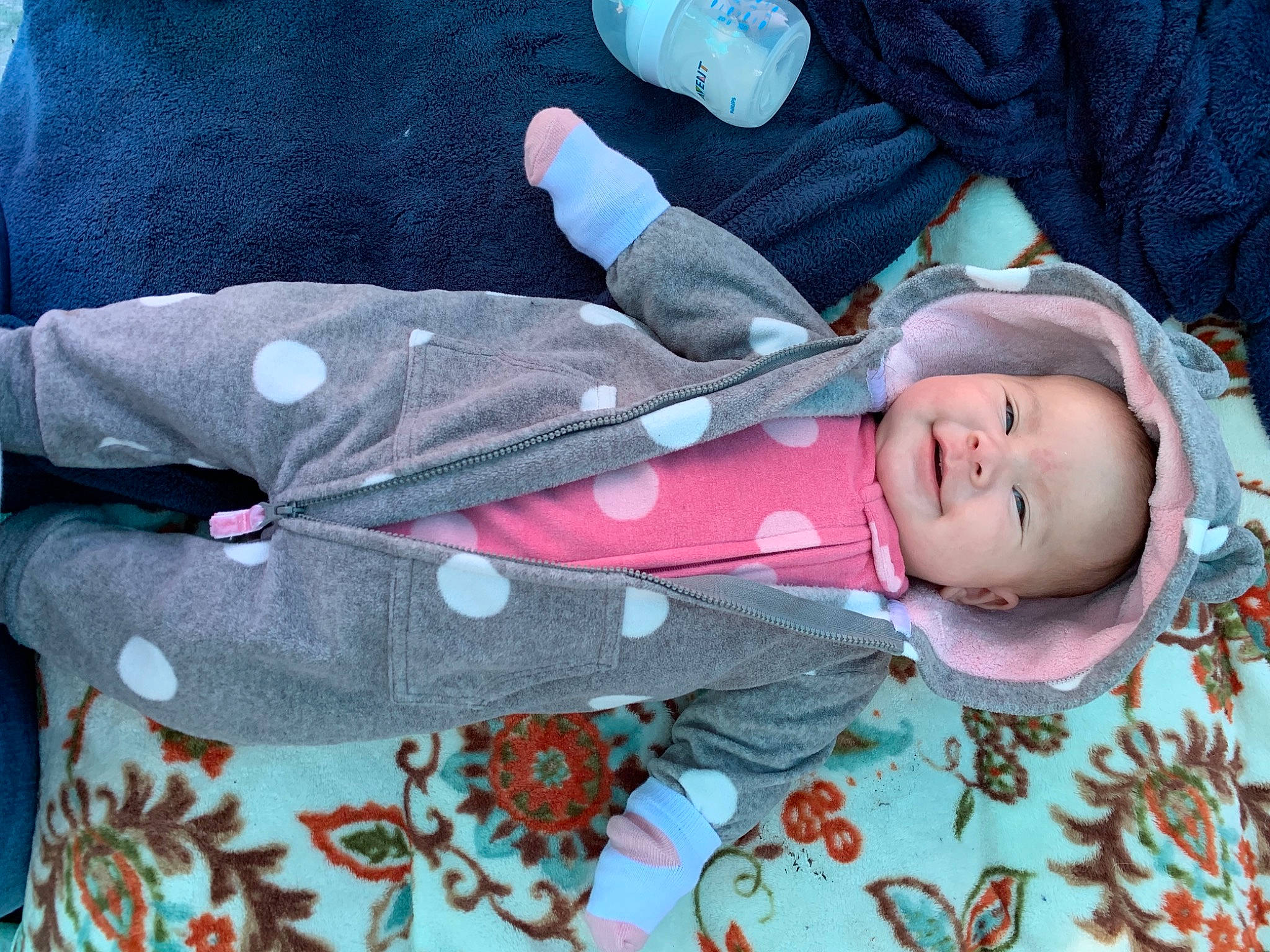 Alyson is registered to the contest to win money with this photo: baby, baby_products, baby_toddler_clothing, child, comfort, face, linens, pattern, person, sleeve, smile, textile, toddler