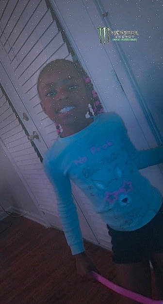 Zarriah joined the competition — help win amazing prizes! chest, costume, darkness, electric_blue, entertainment, event, flesh, fun, human_leg, knee, leisure, magenta, night, person, personal_protective_equipment, pink, room, sitting, sportswear, t_shirt