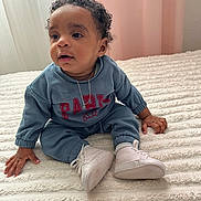 Taylor Malony participe au concours pour gagner de l'argent avec cette photo : baby, blanket, child, curly_hair, curtains, cute, eyes, floor_bed, hands, indoors, infant, necklace, paris_text, pink_curtain, portrait, sitting, sneakers, sweatshirt, white_bedspread, white_shoes