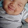 Legend is registered to the contest to win money with this photo: baby, smile, face, infant, onesie, clothing, cloud_pattern, blanket, cute, child, happy, cheeks, portrait, closeup, sleepy, resting, soft, skin, person, indoors