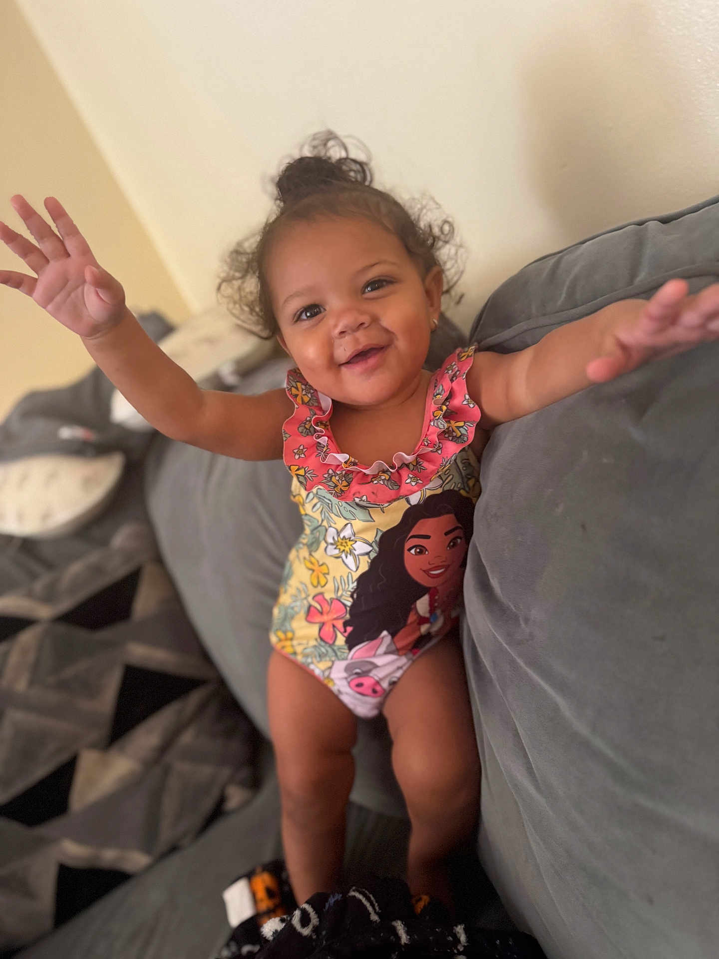 Alauni joined the competition — help win amazing prizes! toddler, child, smiling, curly_hair, swimsuit, couch, indoor, happy, arms_outstretched, cartoon_character, plush, cushion, person, home, cute, portrait, young_child, relaxed, fun, playful