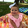 baby, child, smiling, pink_clothing, headband, bow, blanket, outdoor, grass, tree, sunlight, park, happy, cute, sitting, portrait, infant, nature, daylight, young