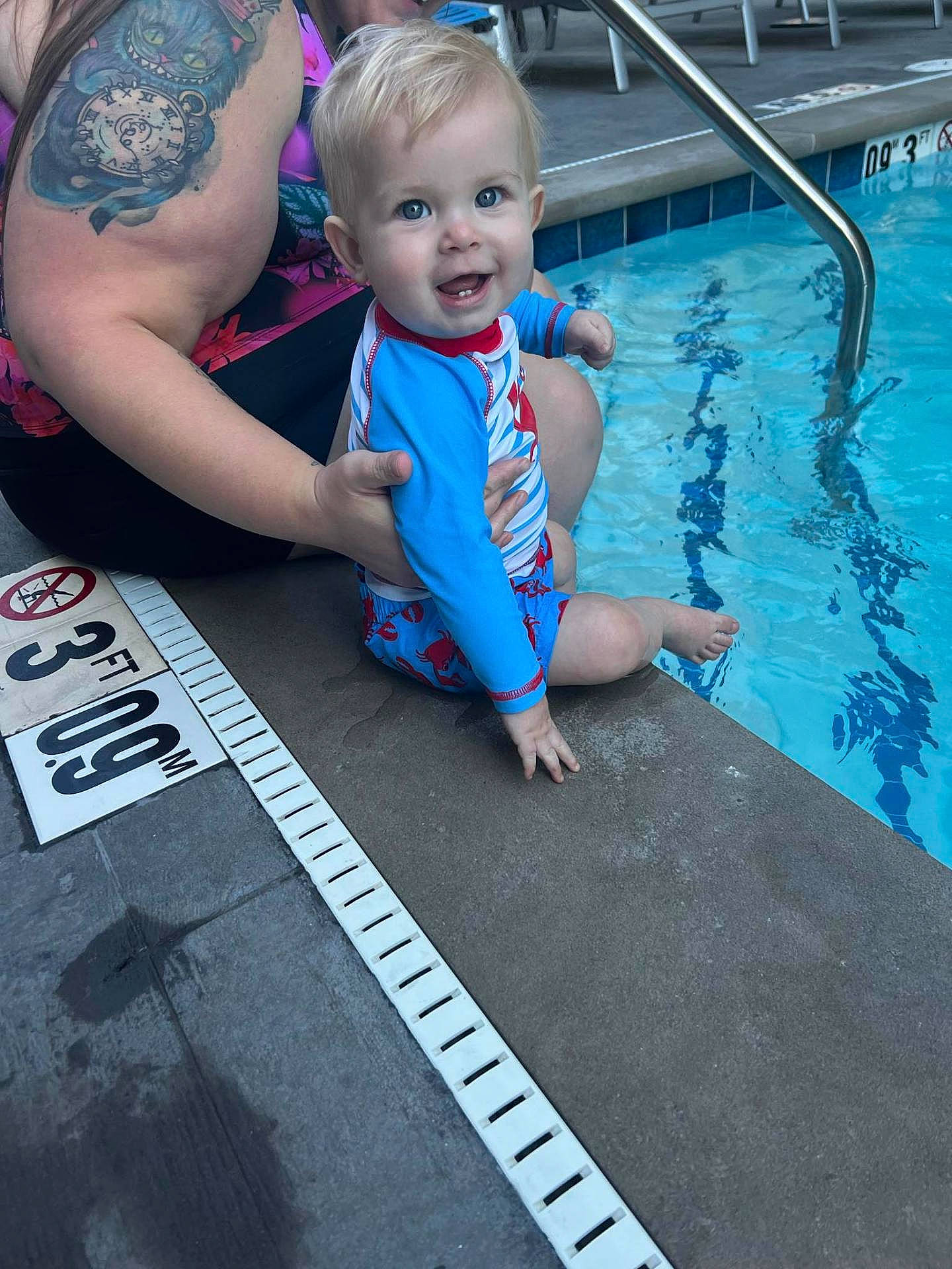 Jameson is registered to the contest to win money with this photo: baby, clothing, face, head, leisureactivities, lifejacket, person, photography, pool, portrait, skin, sport, summer, swimming, swimmingpool, swimwear, tattoo, vest, water, watersports