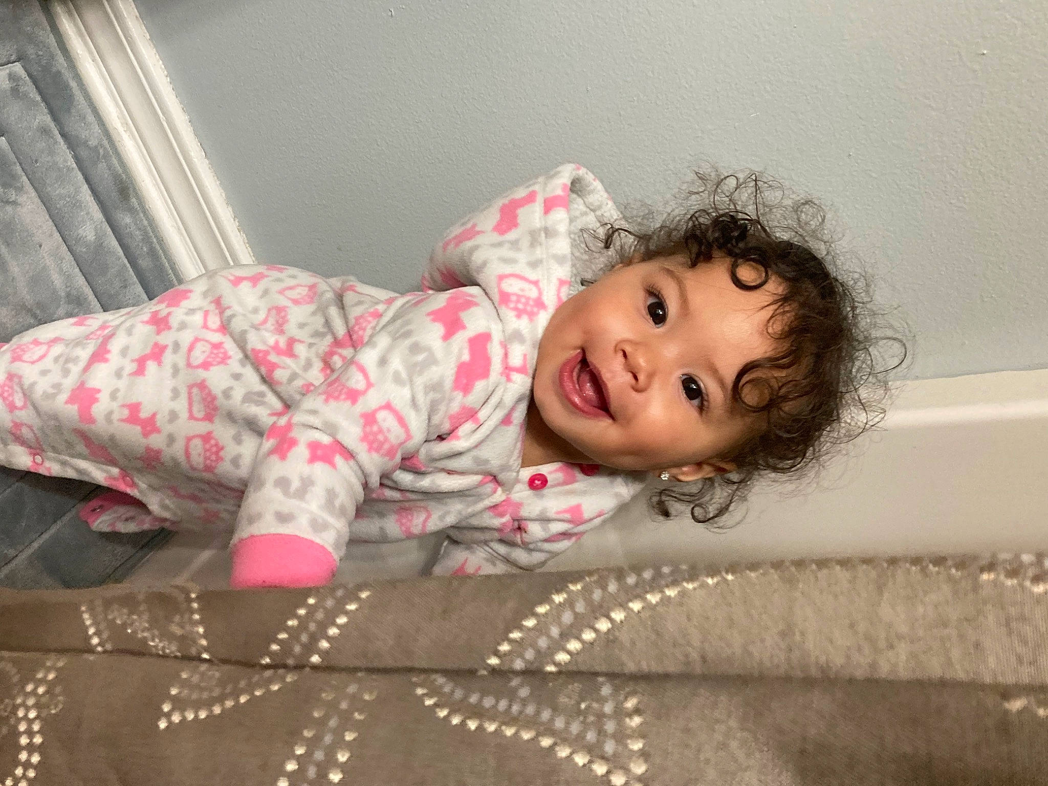 Alicia is registered to the contest to win money with this photo: baby_toddler_clothing, cheek, child, comfort, flash_photography, floor, flooring, happy, human_leg, iris, linens, lip, pattern, person, portrait_photography, room, sitting, skin, sleeve, smile