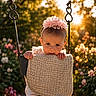 baby, child, swing, flower_headband, sunset, flowers, garden, outdoor, cute, infant, nature, playground, sunlight, portrait, pink_flower, clothing, hands, face, expression, texture