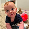 Braylee is registered to the contest to win money with this photo: baby, child, infant, blue_onesie, carpet, red_ball, stuffed_toy, plush_doll, floor, indoor, smiling, curious, portrait, head, arms, person, cute, playful, home, young_child