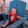 toddler, child, smiling, red_shirt, nike_logo, blue_chair, wooden_chair, pier, ocean, sea, sunset, outdoor, barefoot, happy, baby, person, summer, vacation, casual_clothing, water
