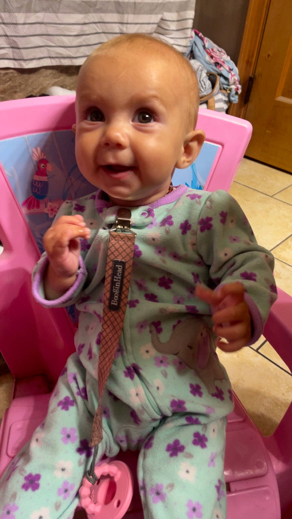 Hailyn is registered to the contest to win money with this photo: baby, baby_toddler_clothing, cheek, child, comfort, face, facial_expression, finger, fun, hairstyle, happy, head, linens, nose, person, pink, sitting, skin, sleeve, smile