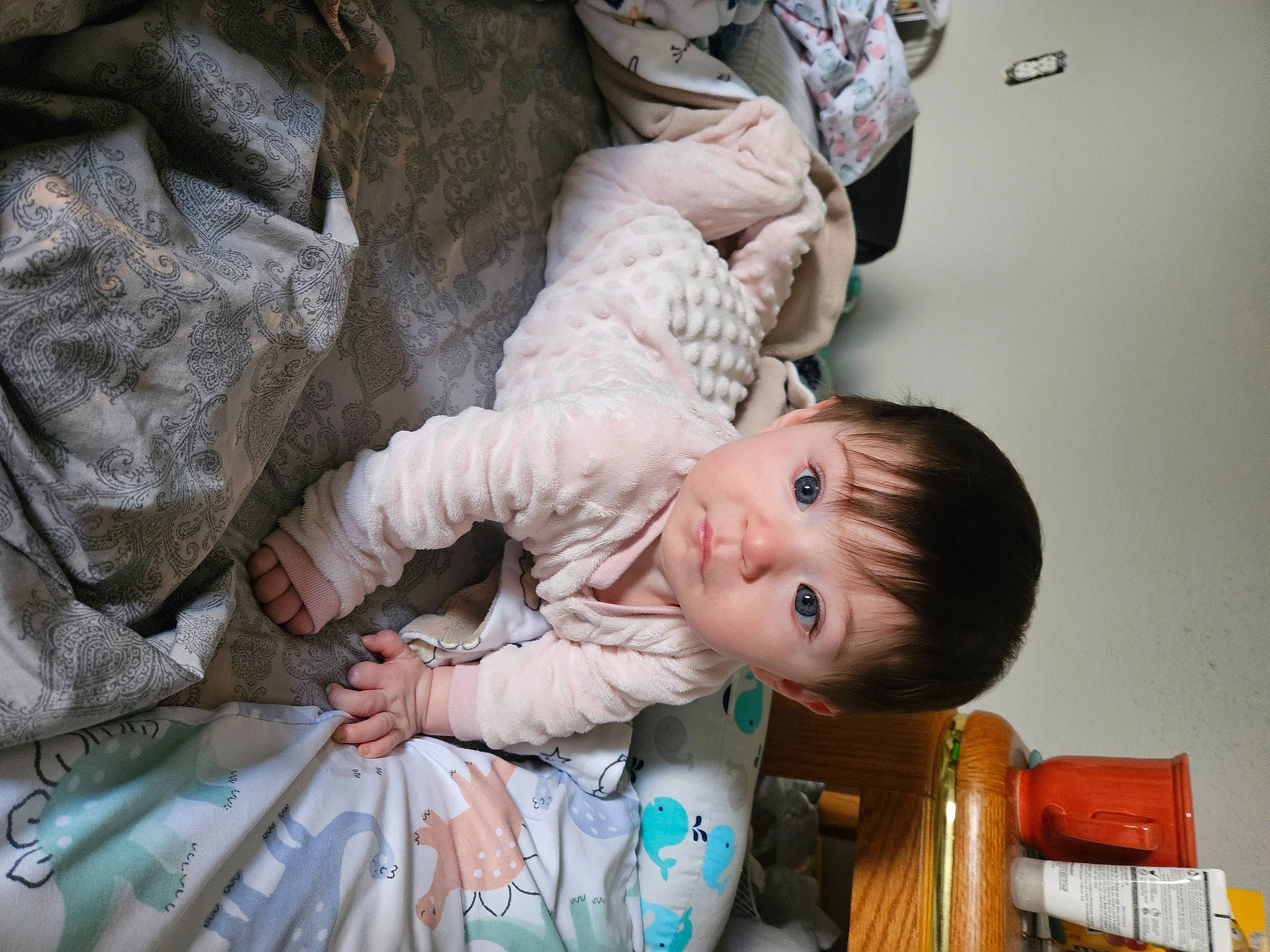 Gabriela is registered to the contest to win money with this photo: baby, baby_products, baby_toddler_clothing, chair, cheek, child, comfort, fun, hand, happy, human_body, linens, person, room, sitting, skin, smile, suit, toddler, tree