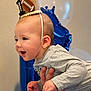 baby, balloon, birthday, blue_balloon, celebration, child, cute, face, first_birthday, gray_shirt, hand, happy, indoors, infant, party_crown, person_holding, portrait, smile, white_balloon, young_child