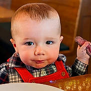 Skyler joined the competition — help win amazing prizes! appetite, baby, child, curious, cute, dining, face, food, hand, indoor, meal, plaid_shirt, portrait, red_suspender, restaurant, smirk, steak, table, toddler, wooden_furniture