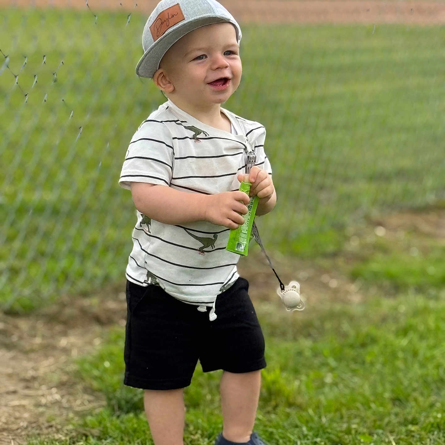 Daylin is registered to the contest to win money with this photo: baseballcap, boy, cap, child, clothing, face, field, footwear, grass, hat, head, male, pants, person, photography, plant, portrait, shoe, shorts, summer