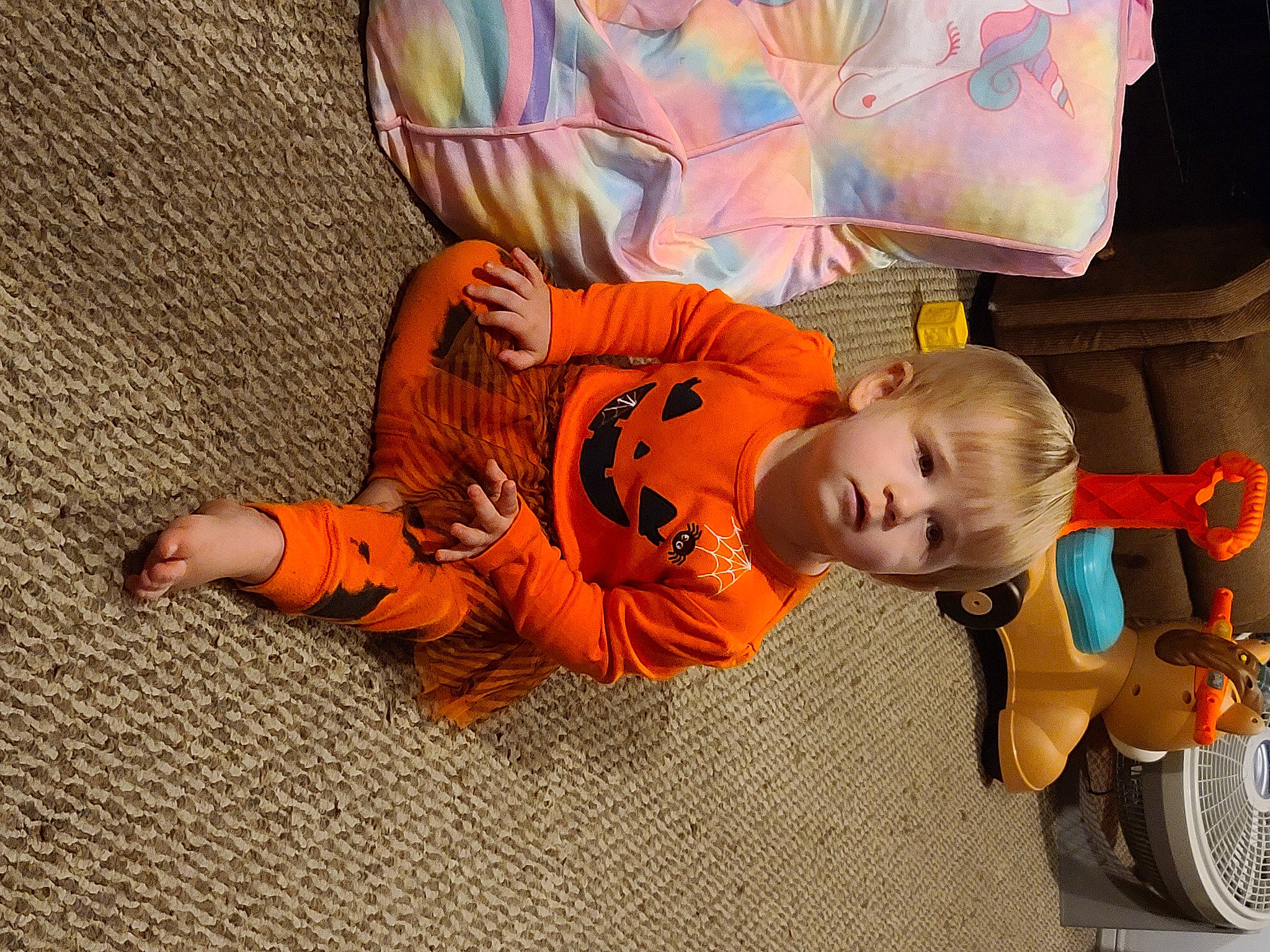 Kassandra is registered to the contest to win money with this photo: art, automotive_tire, baby, baby_products, child, comfort, flooring, fun, motor_vehicle, orange, person, plant, room, sitting, tire, toddler, toy, tree, vehicle, wheel