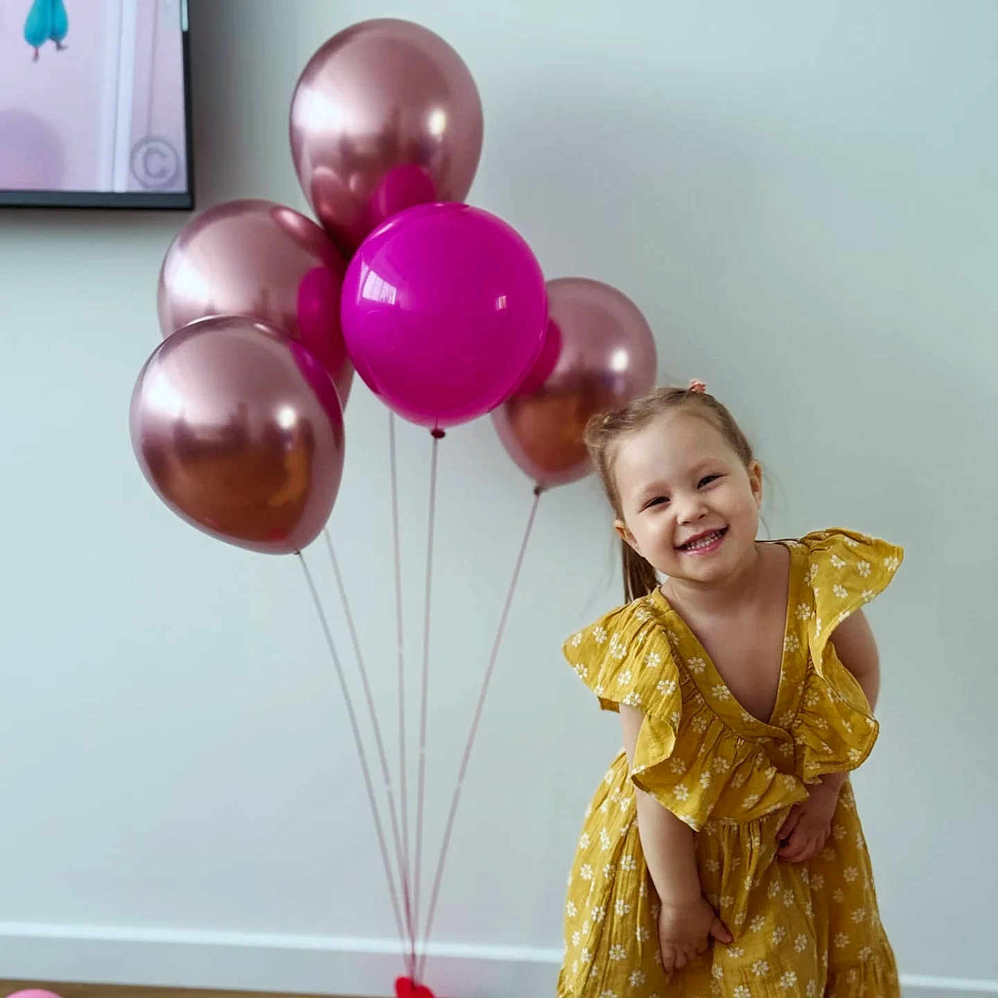 Melisa a rejoint le concours — aidez-le/la à gagner de superbes lots ! child, girl, smiling, yellow_dress, balloons, pink, rose_gold, indoor, happy, playful, celebration, portrait, cute, person, wall, floor, hair, fashion, fun, decor