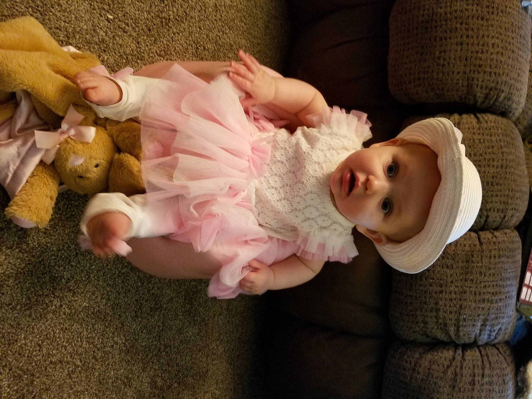 Emilee is registered to the contest to win money with this photo: baby, baby_toddler_clothing, cheek, child, comfort, dress, embellishment, eye, face, fashion_accessory, happy, hat, head, headgear, headwear, human_body, person, pink, sitting, skin