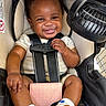 Kyrie is registered to the contest to win money with this photo: baby, smile, car_seat, infant, child, footwear, socks, happiness, seatbelt, fan, comfort, cute, portrait, indoors, young_child, clothing, sitting, baby_shoes, infant_toddler, child_seat