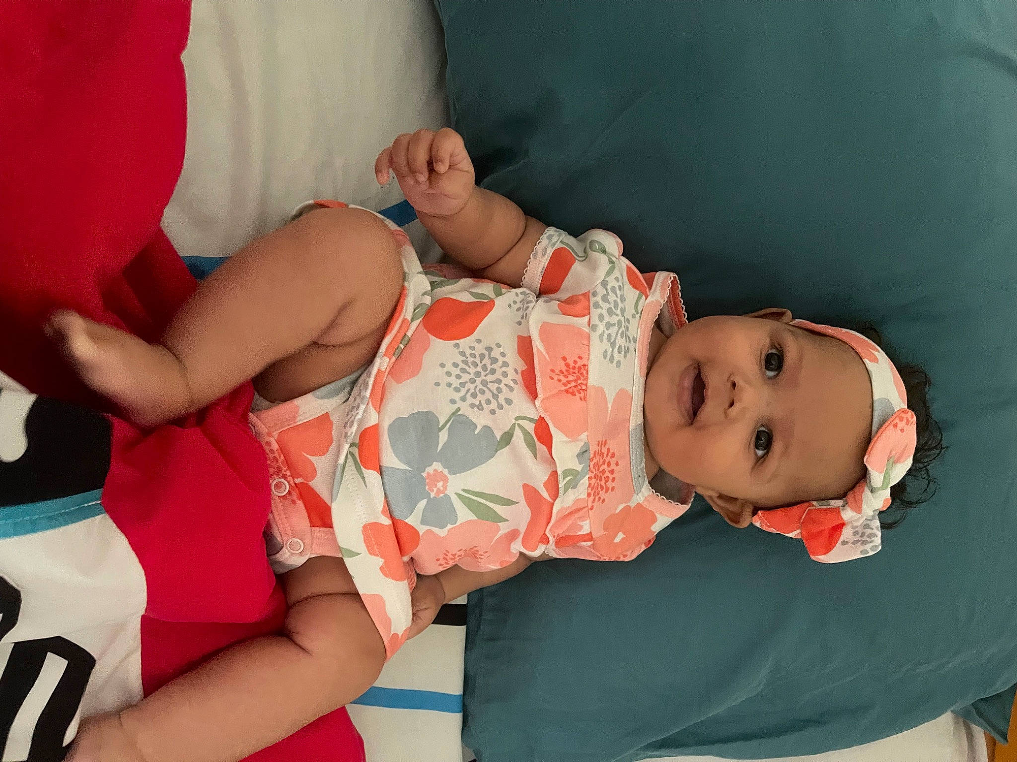 Jayla is registered to the contest to win money with this photo: arm, baby, baby_toddler_clothing, cheek, child, facial_expression, finger, hand, happy, headwear, human_body, lap, pattern, person, pink, product, skin, sleeve, textile, thigh