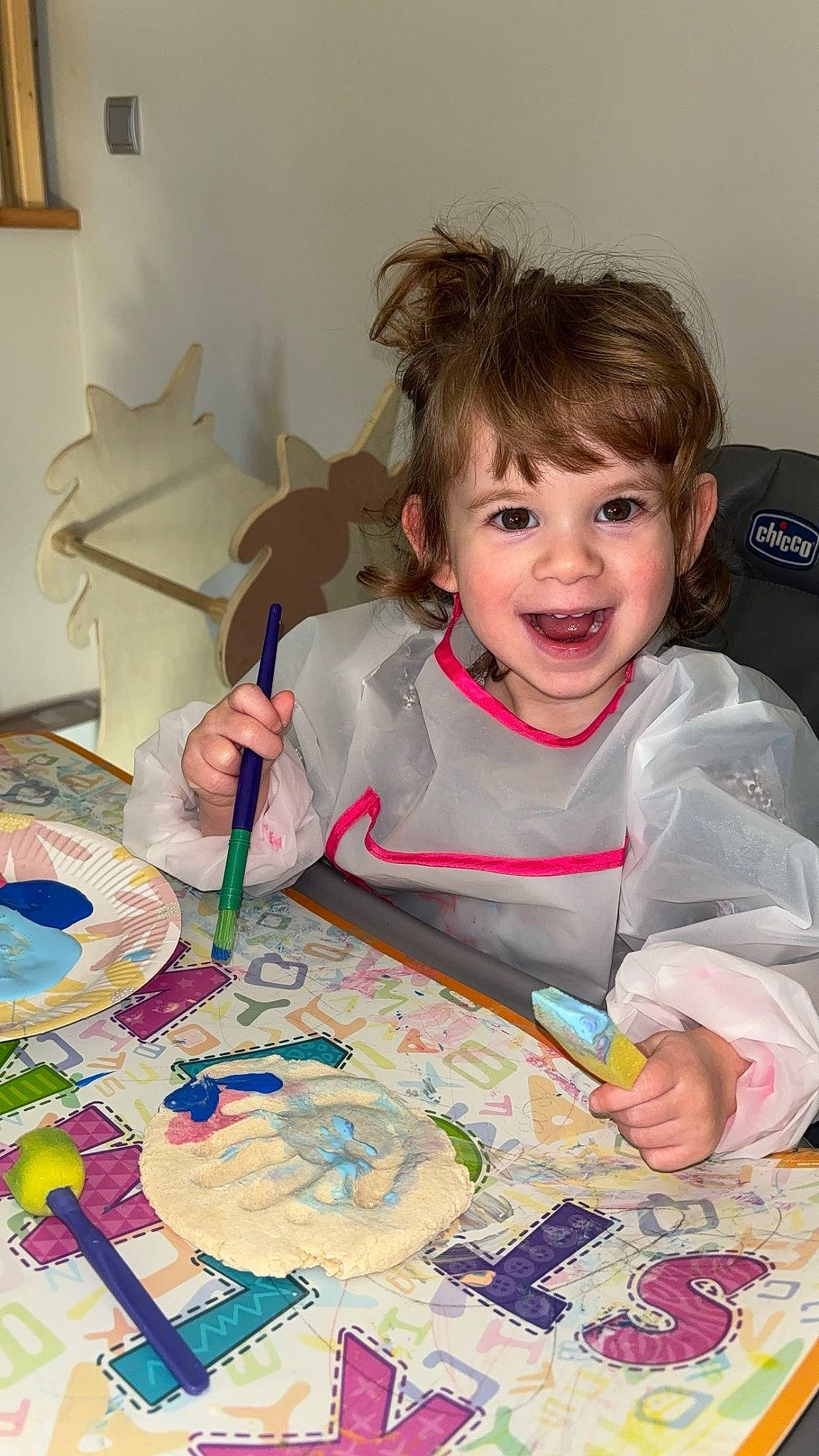 Ava participe au concours pour gagner de l'argent avec cette photo : art, artist, baby_toddler_clothing, chair, child, event, fun, happy, paint, people, person, picture_frame, play, recreation, room, smile, table, tableware, textile, toddler