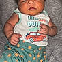 Knox joined the competition — help win amazing prizes! baby, infant, child, face, hair, clothing, tank_top, shorts, pattern, sun_pattern, car_print, fist, expression, laying, blanket, soft, skin, cute, indoors, portrait
