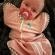 Laken joined the competition — help win amazing prizes! baby, infant, newborn, pacifier, swaddle, blanket, pink, face, eyes, portrait, cozy, clothing, zipper, hair, skin, lying_down, closeup, soft_texture, indoor, babywear