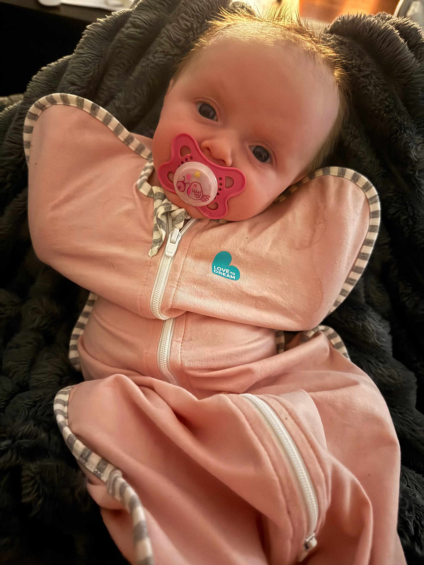 Laken joined the competition — help win amazing prizes! baby, infant, newborn, pacifier, swaddle, blanket, pink, face, eyes, portrait, cozy, clothing, zipper, hair, skin, lying_down, closeup, soft_texture, indoor, babywear