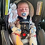 Asher is registered to the contest to win money with this photo: baby, car_seat, pacifier, infant, sleeping, onesie, dinosaur_pattern, safety_harness, blanket, child, cute, indoors, seatbelt, resting, newborn, clothing, toddler, comfort, head_support, soft_toy