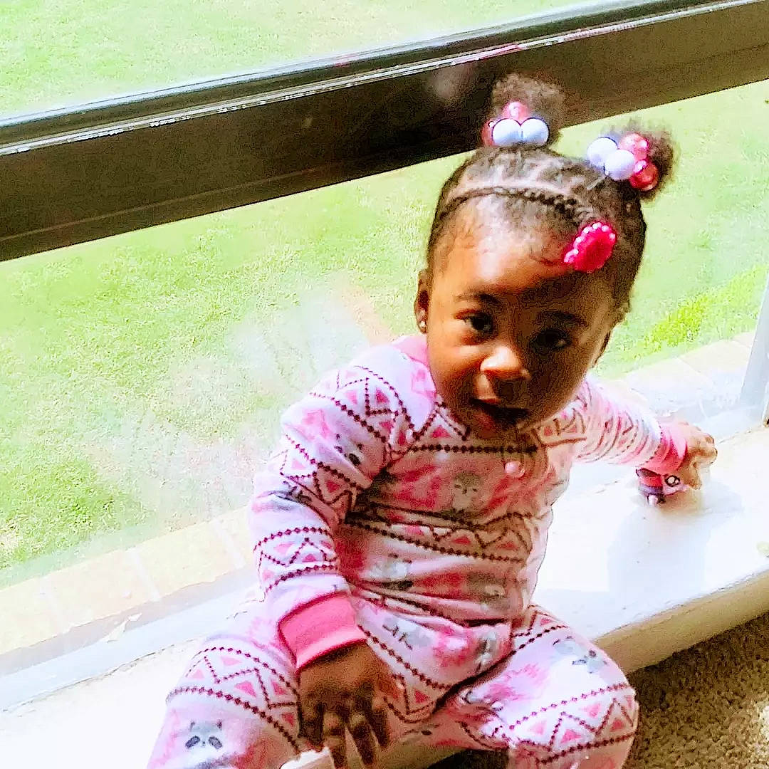 Makaiyah is registered to the contest to win money with this photo: baby_toddler_clothing, black_hair, child, chin, fashion_accessory, fun, grass, hair_accessory, happy, headband, leisure, magenta, neck, pattern, person, pink, sitting, skin, sleeve, smile