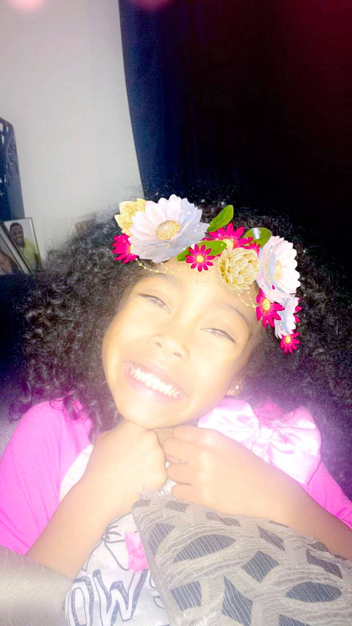 Semaj is registered to the contest to win money with this photo: beauty, black_hair, cheek, child, day, face, flower, fun, girl, hair, hair_accessory, hairstyle, head, headpiece, human_hair_color, joy, person, petal, pink, purple