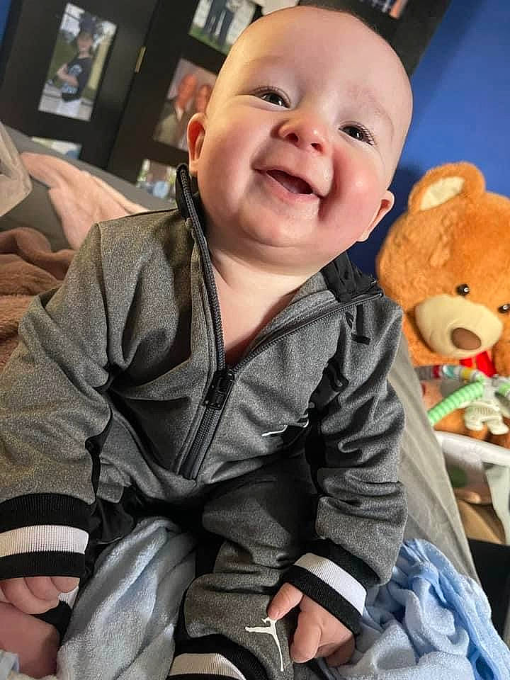 Nolan is registered to the contest to win money with this photo: baby, baby_toddler_clothing, cheek, child, comfort, finger, fun, happy, human, lap, mouth, organ, person, product, skin, sleeve, smile, textile, thumb, toddler