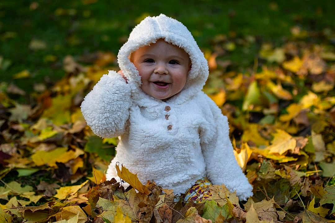 Giovanna is registered to the contest to win money with this photo: autumn, baby, baby_toddler_clothing, child, deciduous, eye, flash_photography, fun, grass, happy, head, headwear, leaf, people_in_nature, person, plant, portrait_photography, sitting, smile, toddler