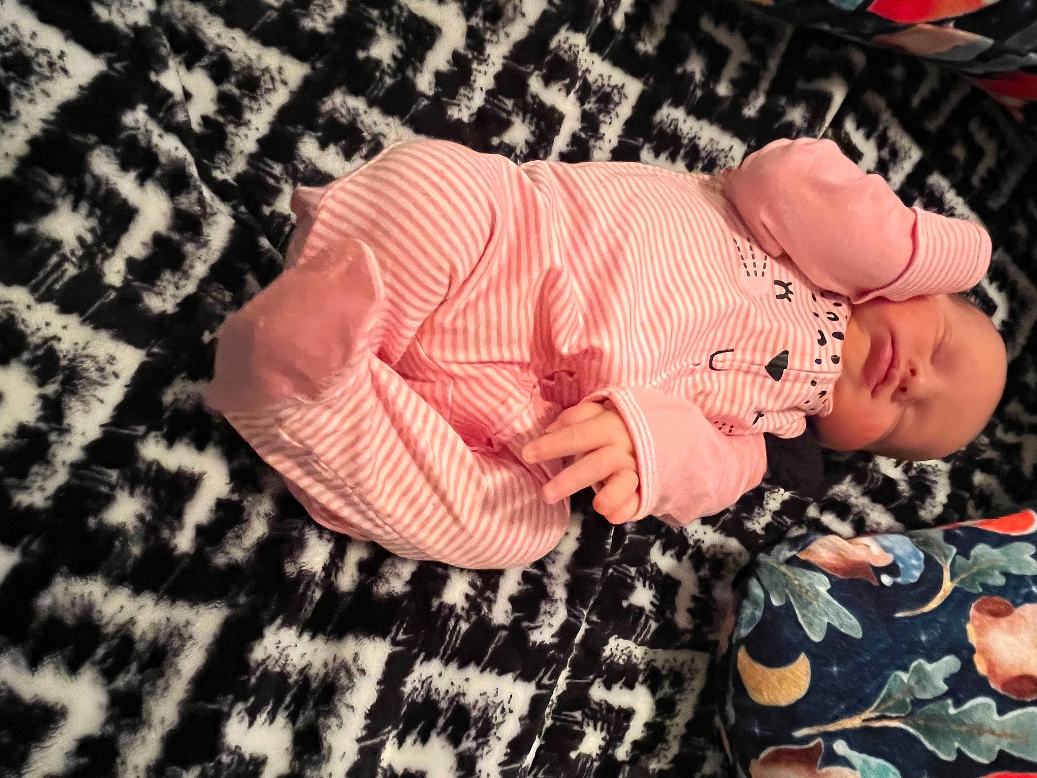 Oakley is registered to the contest to win money with this photo: baby, baby_products, baby_sleeping, baby_toddler_clothing, child, comfort, fashion_accessory, flesh, gesture, hand, happy, linens, nail, pattern, peach, person, sleeve, thumb, toddler, wood