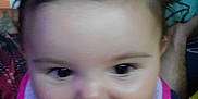 Nyla is registered to the contest to win money with this photo: baby, bib, child, closeup, clothing, cute, expression, eyes, face, hair, happy, head, indoor, infant, mouth, person, portrait, skin, smile, young