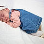 Mélaëlle Et Amaryah participe au concours pour gagner de l'argent avec cette photo : baby, newborn, infant, sleeping, headband, bow, denim_dress, pink_shirt, white_blanket, tights, shoe, portrait, soft_texture, cozy, peaceful, cheek, closed_eyes, studio_style, cute, nursery