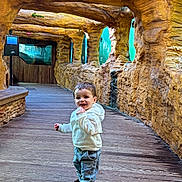 Ruben participe au concours pour gagner de l'argent avec cette photo : child, toddler, smile, hoodie, jeans, boots, wooden_floor, rock_wall, cave_like, aquarium_windows, glass, corridor, indoor, walking, happy, portrait, cute, young_child, family, tourist_attraction