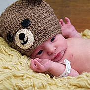 Henry joined the competition — help win amazing prizes! baby, infant, newborn, knitted_hat, button_eyes, bear_hat, blanket, yarn_texture, hospital_band, wristband, face, eyes, hand, chest, skin, portrait, cozy, sleepy, lying_down, cute