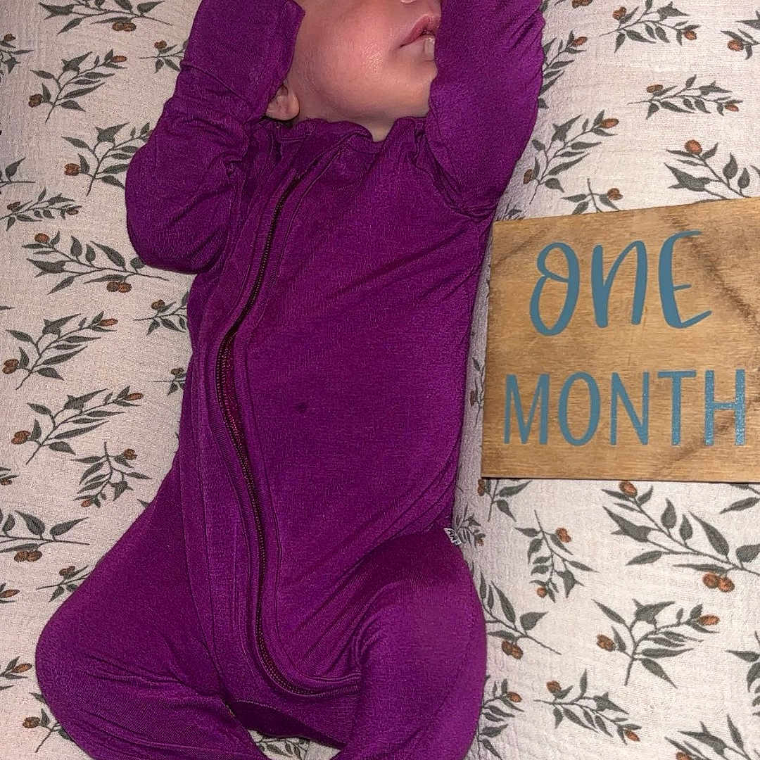 Ivy joined the competition — help win amazing prizes! baby, bed, bedroom, clothing, cushion, face, furniture, glove, head, homedecor, indoors, newborn, pajamas, pants, person, photography, portrait, purple, room, sleeping