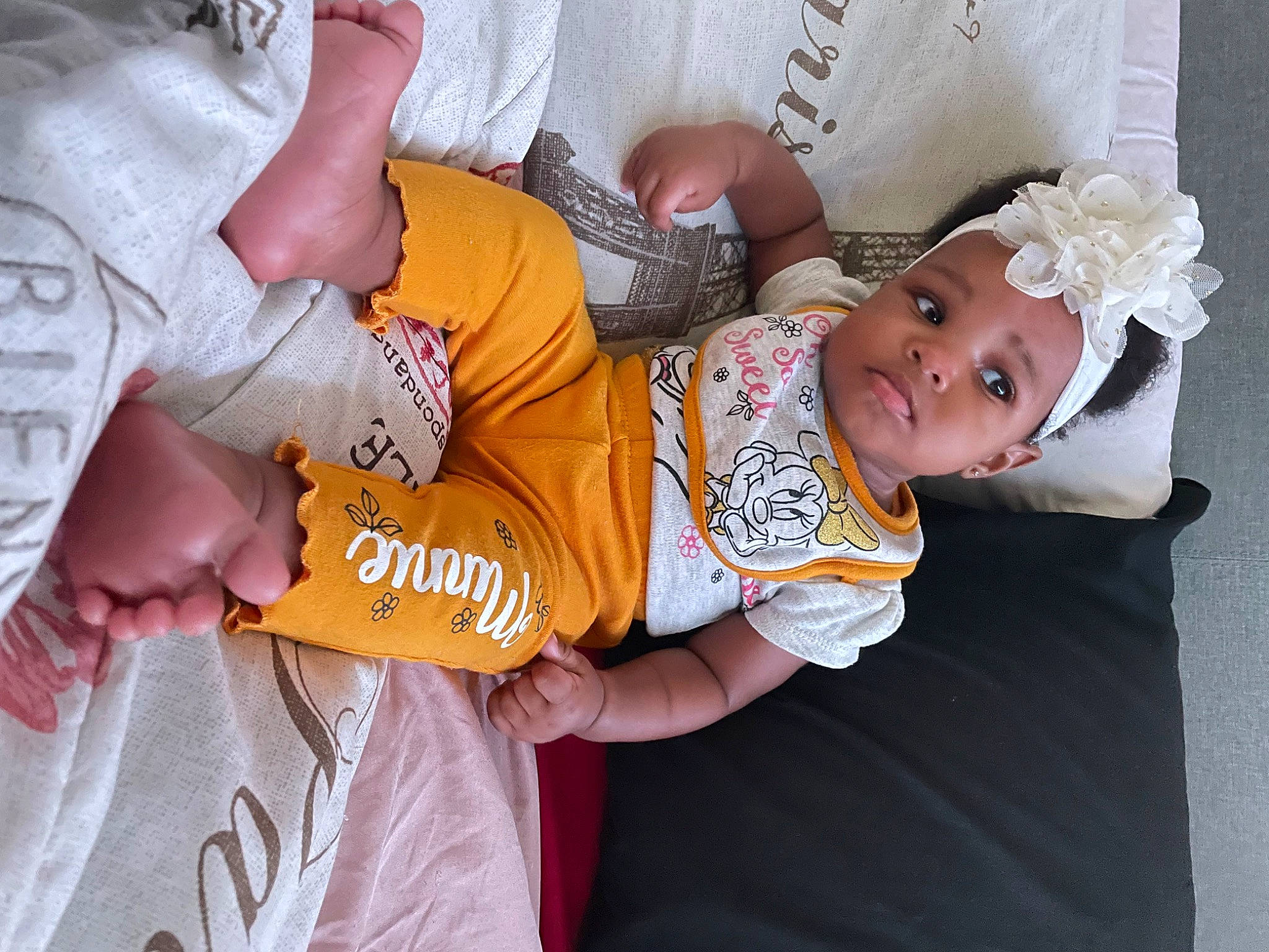 Zamaya is registered to the contest to win money with this photo: baby, baby_toddler_clothing, child, comfort, elbow, facial_expression, gesture, happy, human_body, leg, mouth, person, pink, skin, sleeve, t_shirt, textile, thigh, toddler, trunk