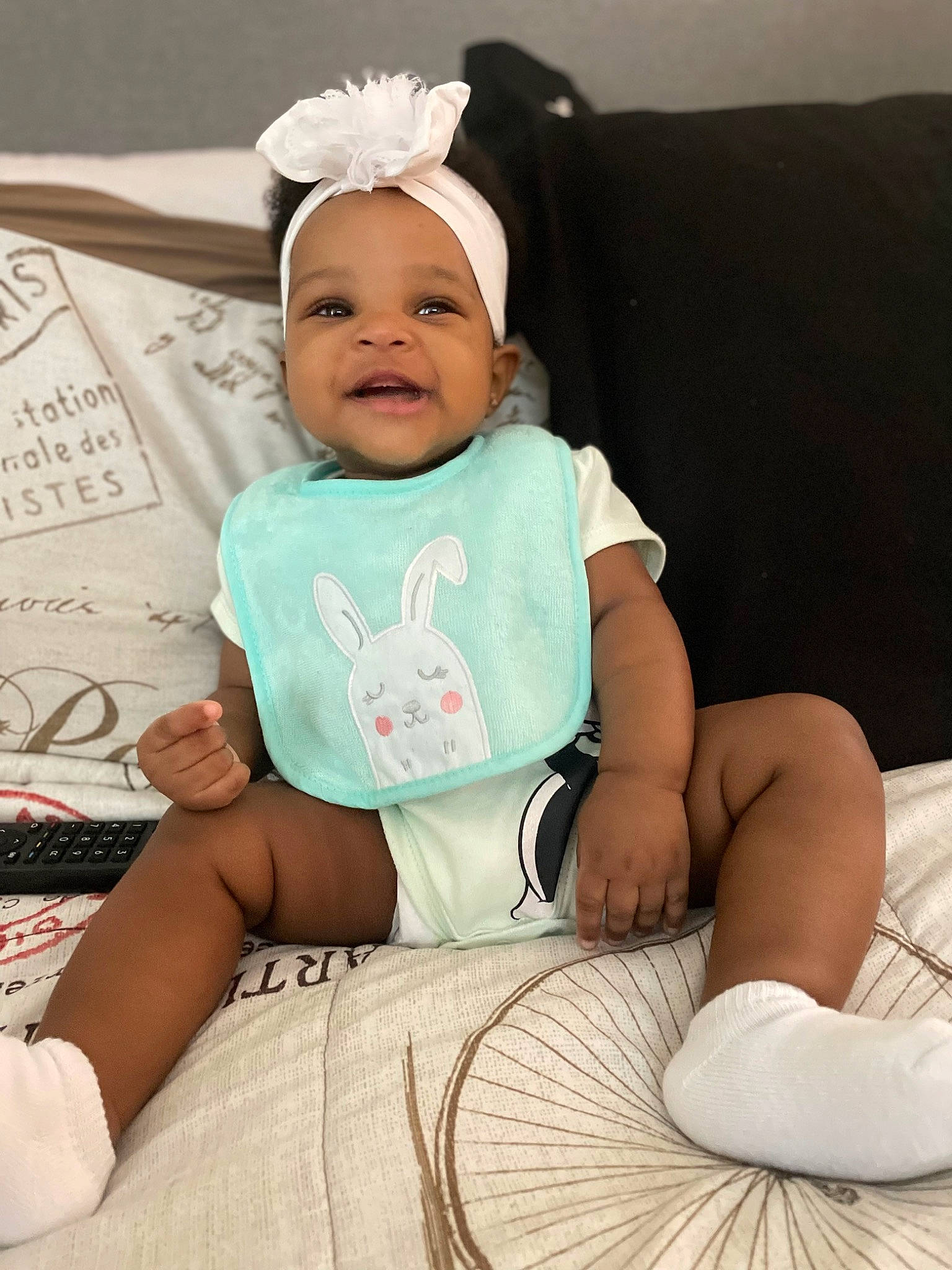 Zamaya is registered to the contest to win money with this photo: baby, baby_products, baby_toddler_clothing, cap, child, comfort, eye, fashion_accessory, happy, hat, headgear, linens, person, sitting, skin, sleeve, smile, t_shirt, textile, toddler