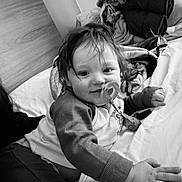 Henry joined the competition — help win amazing prizes! baby, pacifier, bed, blanket, black_and_white, child, toddler, indoors, sleeping_area, clothing, portrait, cute, messy_hair, hand, face, person, soft_toys, comfort, relaxing, cozy