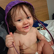 Henry is registered to the contest to win money with this photo: baby, child, diaper, smile, happy, bed, blanket, purple_basket, face, skin, hand, hair, indoors, cute, playful, person, infant, expression, sitting, drool