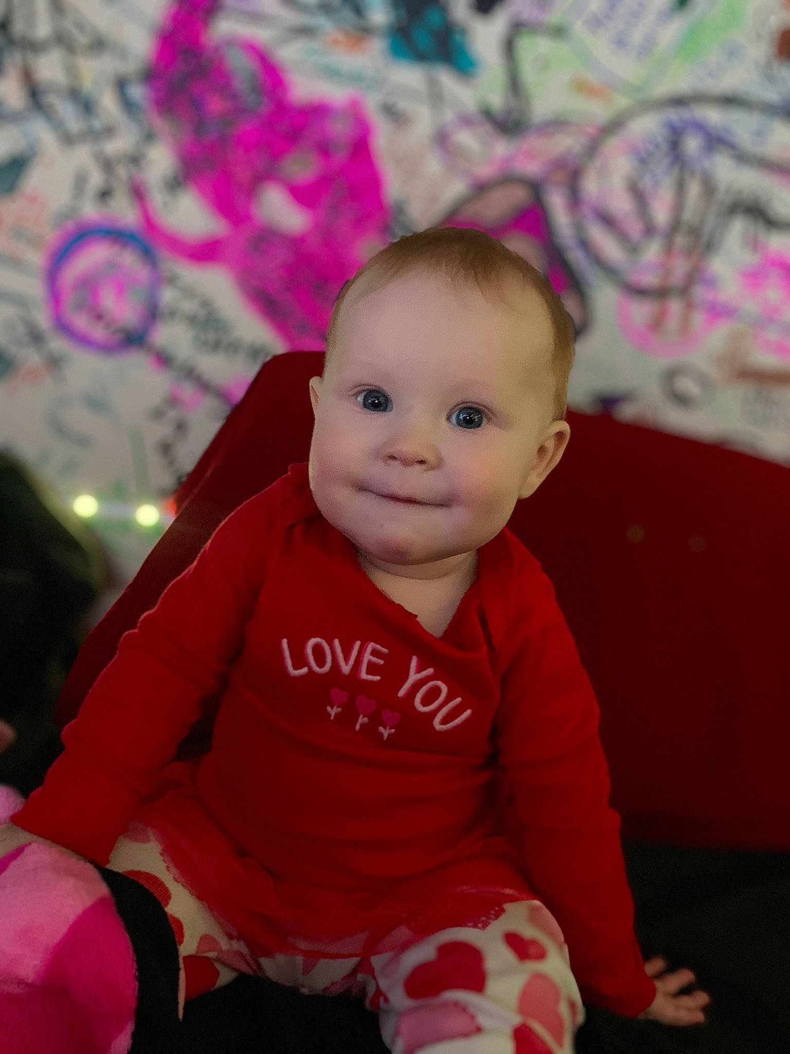 Luna joined the competition — help win amazing prizes! baby, baby_toddler_clothing, cheek, child, comfort, eye, flooring, fun, happy, head, magenta, person, pink, purple, sitting, skin, sleeve, smile, textile, toddler