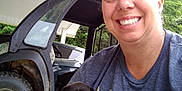 Pepper Ann is registered to the contest to win money with this photo: canopy, casual, dog, face, happy, head, human, nature, outdoor, person, pet, portrait, puppy, shirt, smile, tire, trees, vehicle, wheel, young_dog