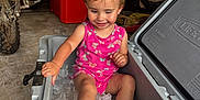 Arizona is registered to the contest to win money with this photo: toddler, child, cooler, ice, garage, motorcycle, tools, pink_clothing, smiling, sitting, playful, concrete_floor, storage, casual, indoor, happy, short_hair, cute, person, container