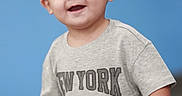 Cruz joined the competition — help win amazing prizes! child, toddler, smiling, happy, portrait, boy, short_hair, grey_tshirt, new_york, indoor, blue_background, cute, casual_clothing, young_child, person, face, standing, expression, joyful, playful