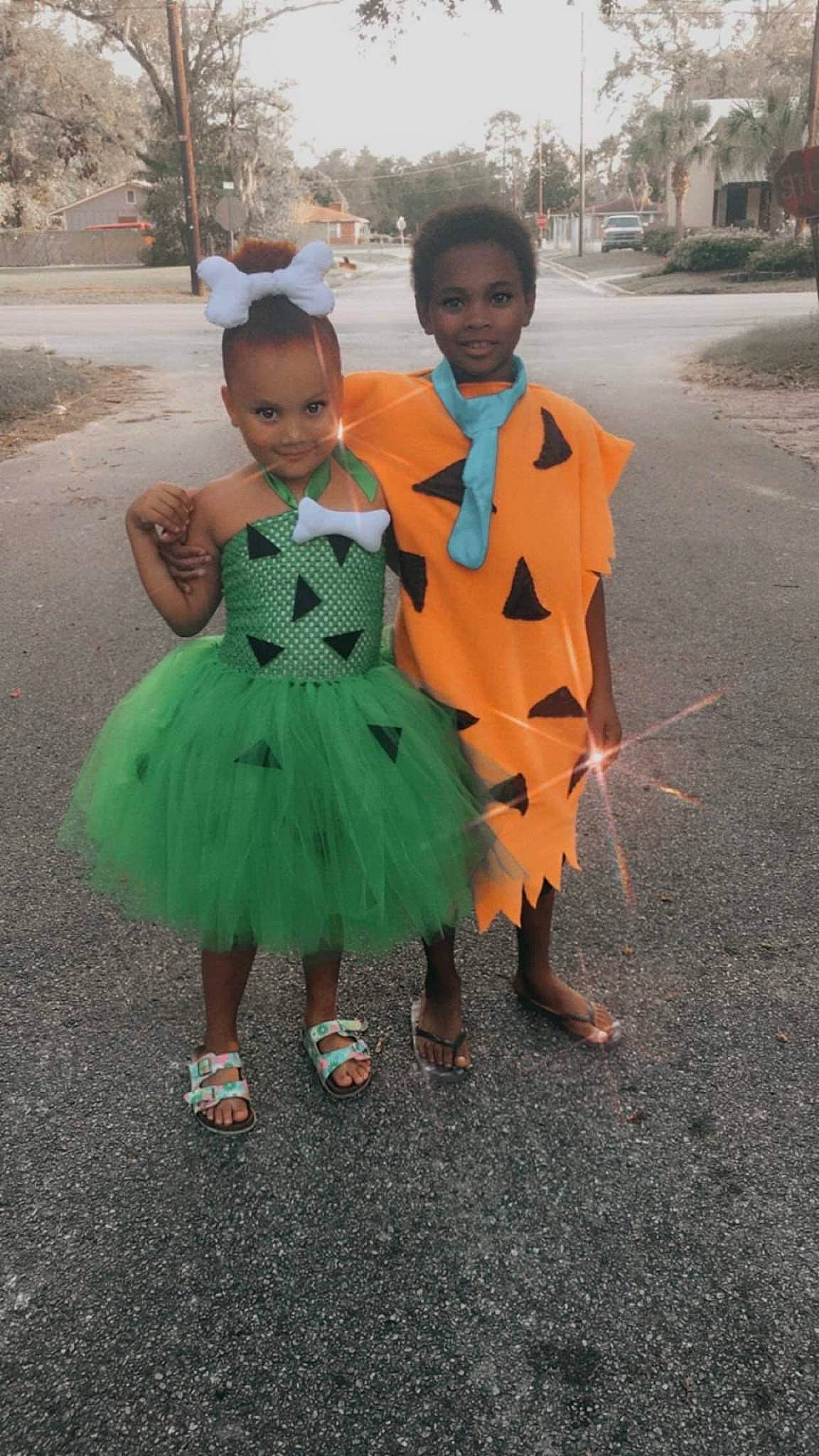 Kylee Rae is registered to the contest to win money with this photo: asphalt, child, costume, dress, event, formal_wear, fun, grass, happy, joy, pattern, people_in_nature, person, plant, road, sky, toddler, tradition, tree, trick_or_treat