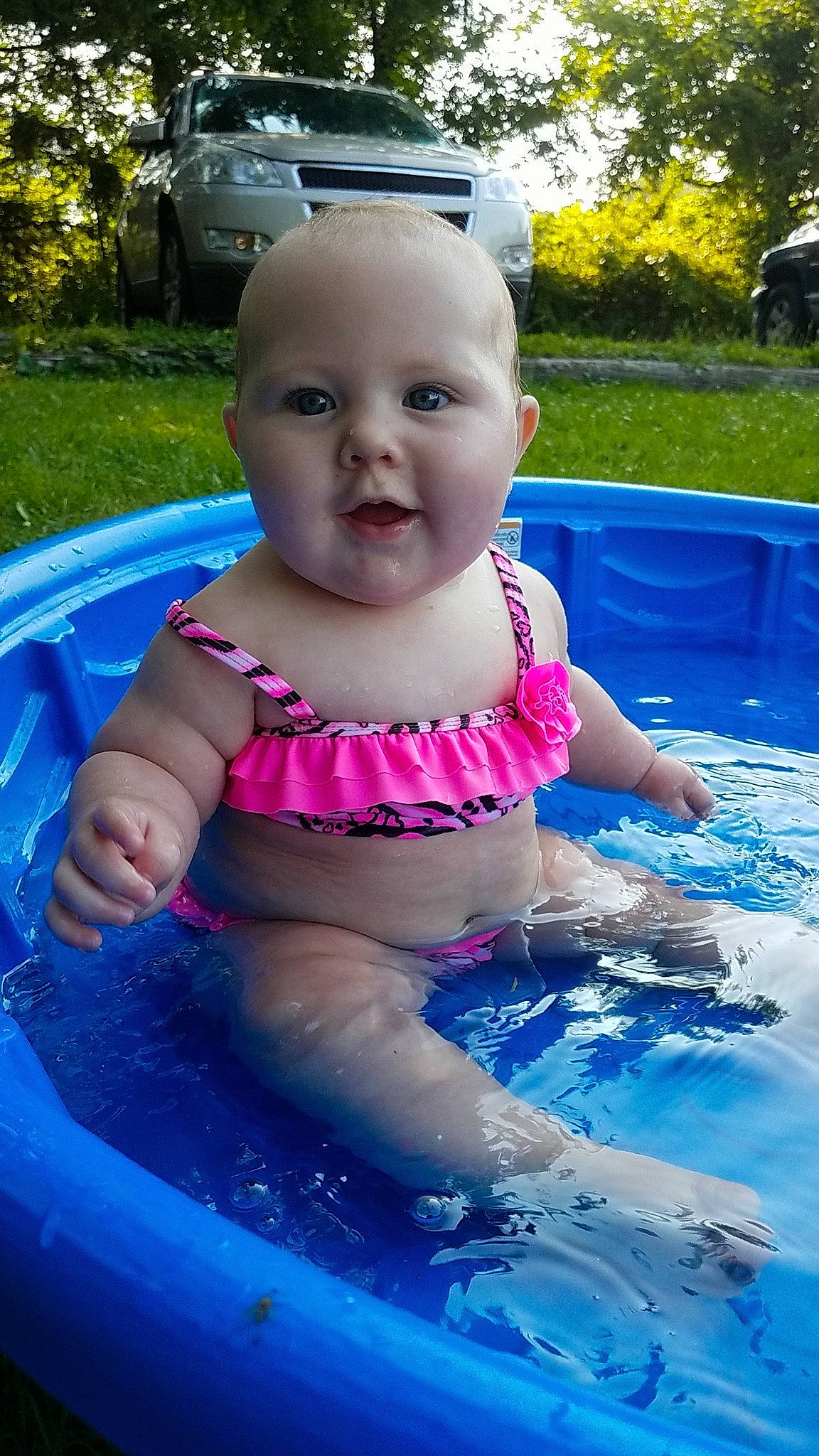 Khloe is registered to the contest to win money with this photo: baby, child, fun, games, leisure, person, pink, play, recreation, skin, smile, summer, swimming_pool, toddler, vacation, water